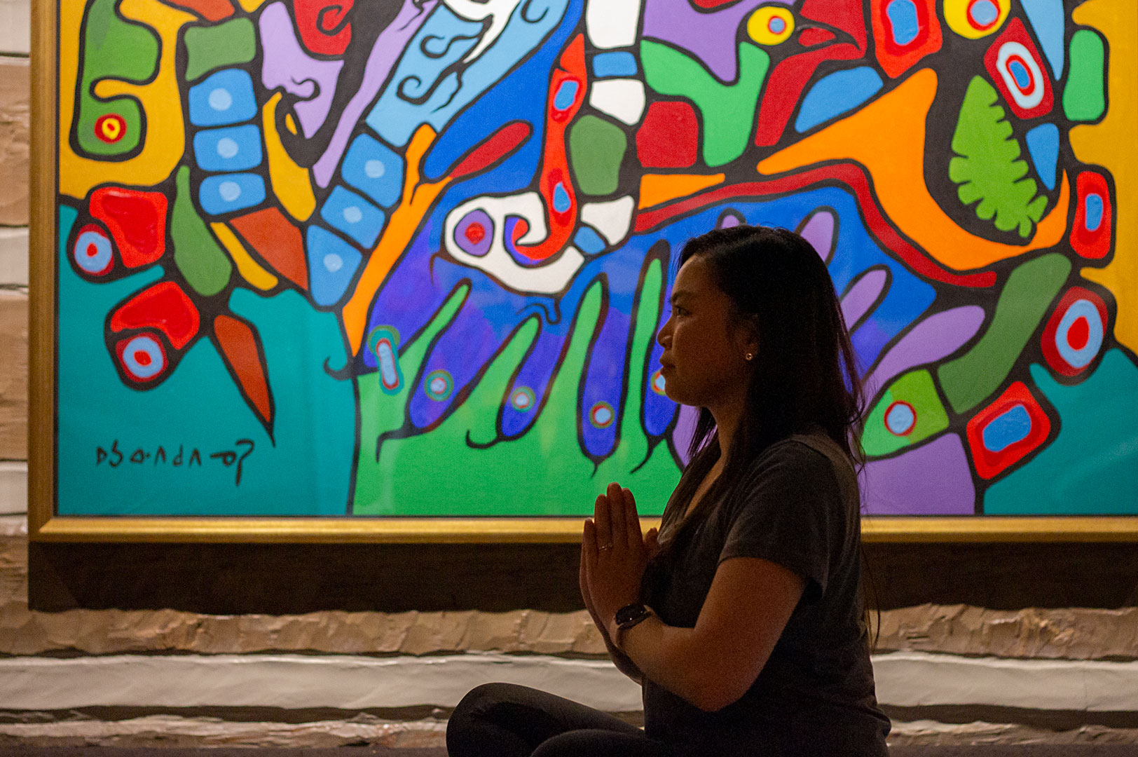 Woman in yoga pose inside art gallery