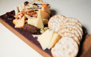 photo of crackers and cheese on a wooden board