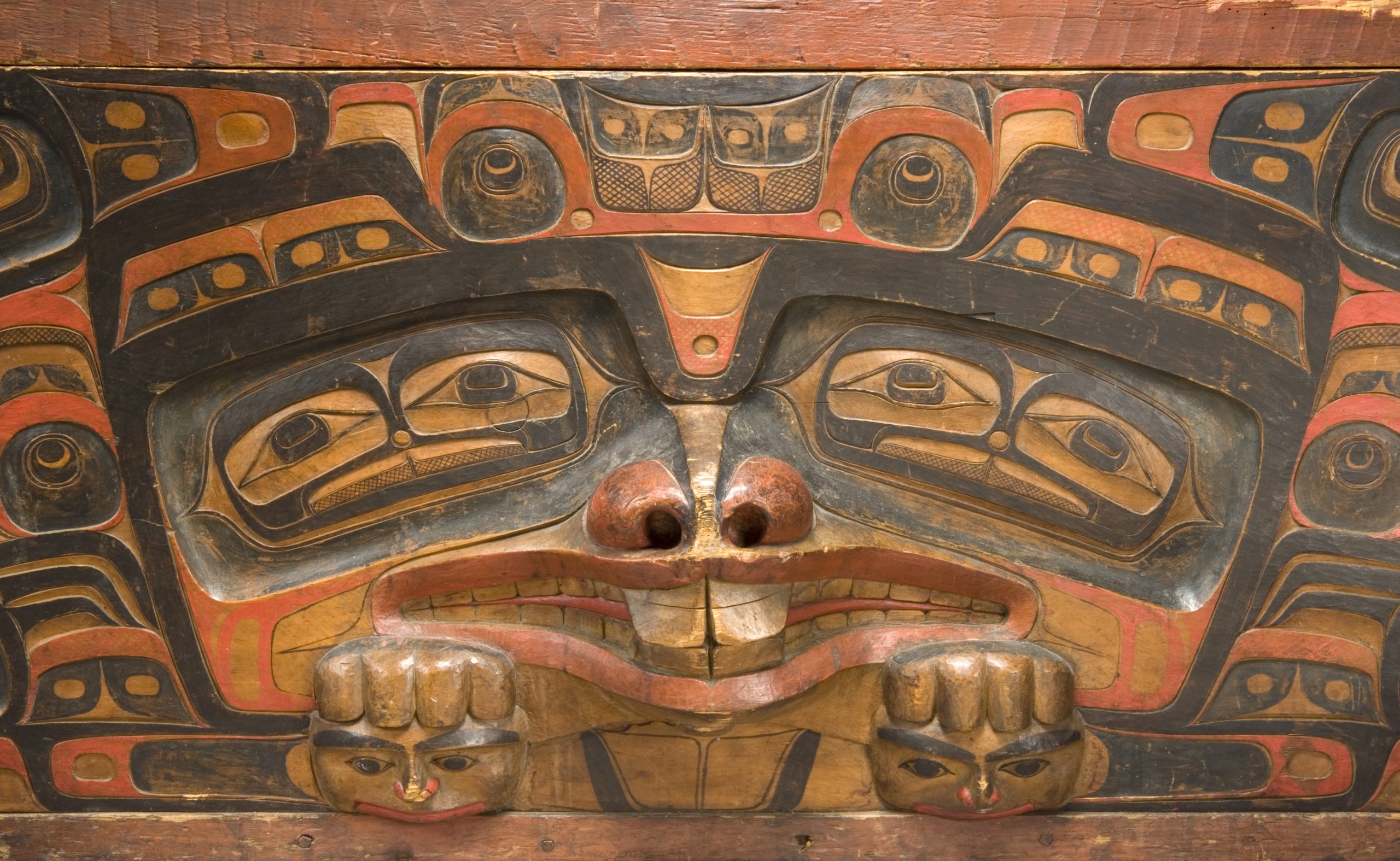 carved wood with stylized painted images