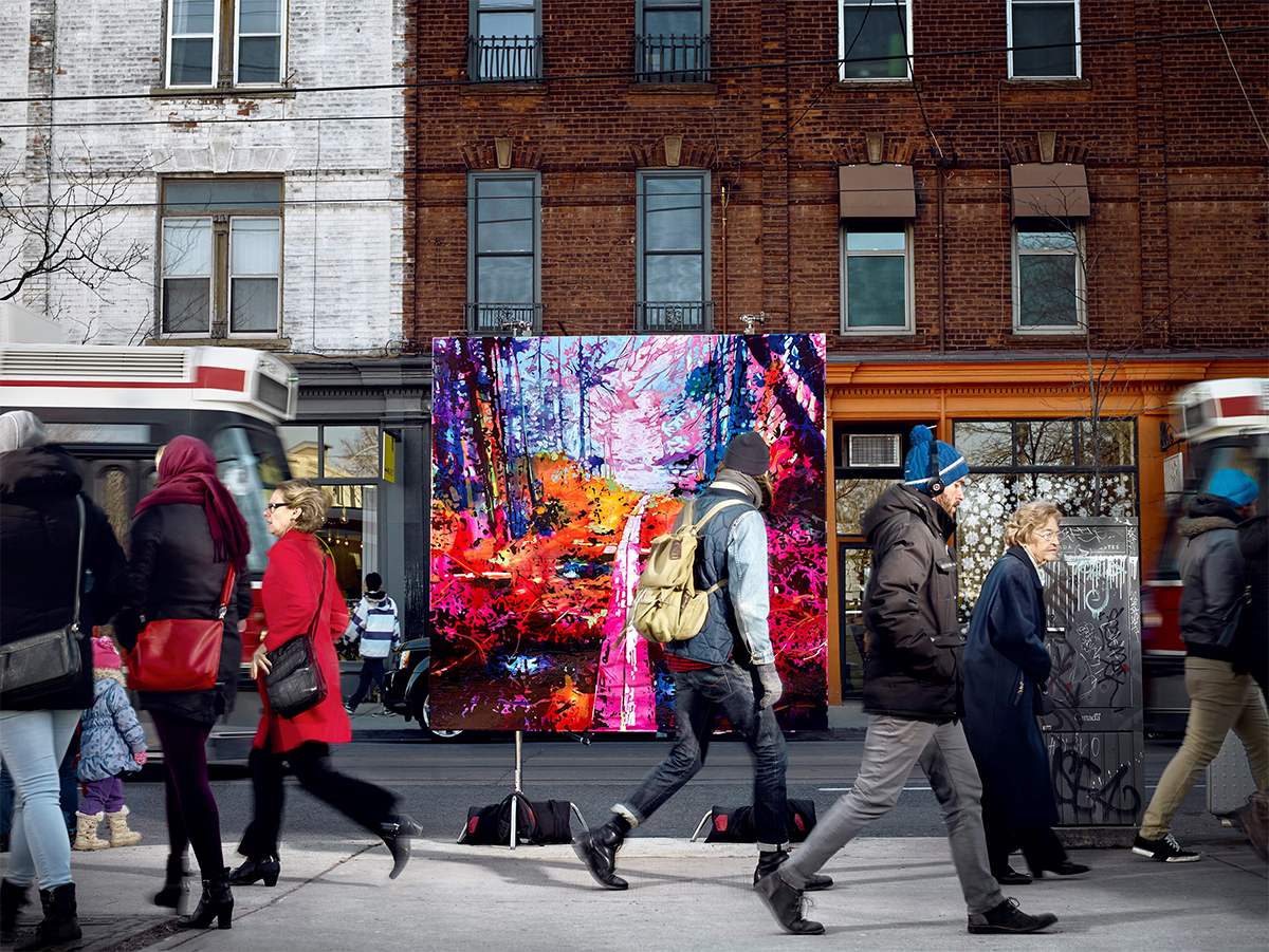photograph of a painting of a woodland scene on a stand in a busy urban street