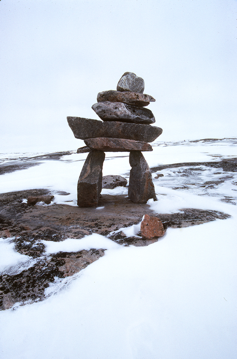 photograph of rock structure in a rocky and snowy landscape