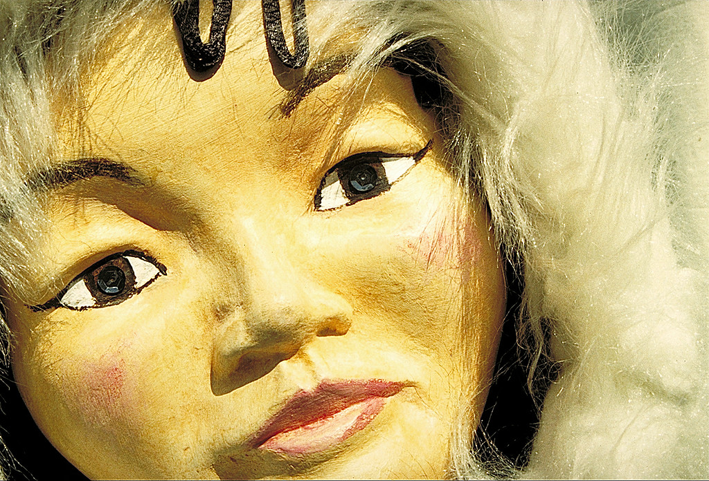 sculpture of a woman's face with white fur around her head