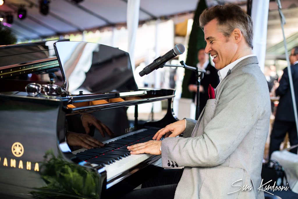 photograph of a man playing a grand piano